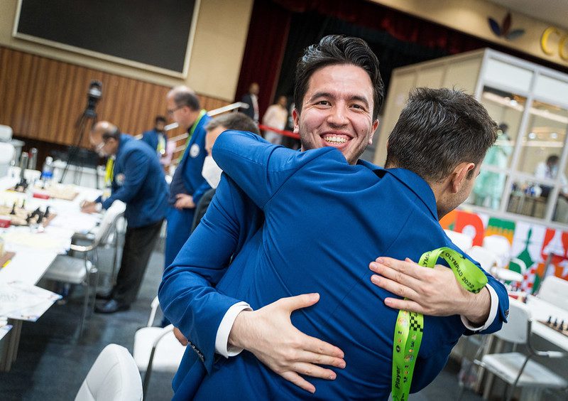 akhongir Vakhidov, the senior member at age 27, is greeted by Nodirbek Yakubboev after clinching the medal for Uzbekistan. Captain Ivan Sokolov is in the background. Photo by Lennart Ootes