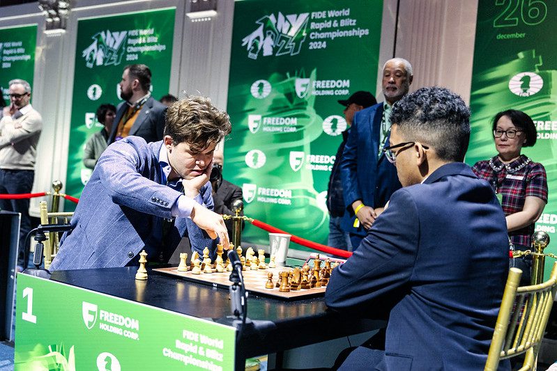 Carlsen adjusting pieces before playing 1.Nf3 against Hardaway.
Photo by Maria Emelianova